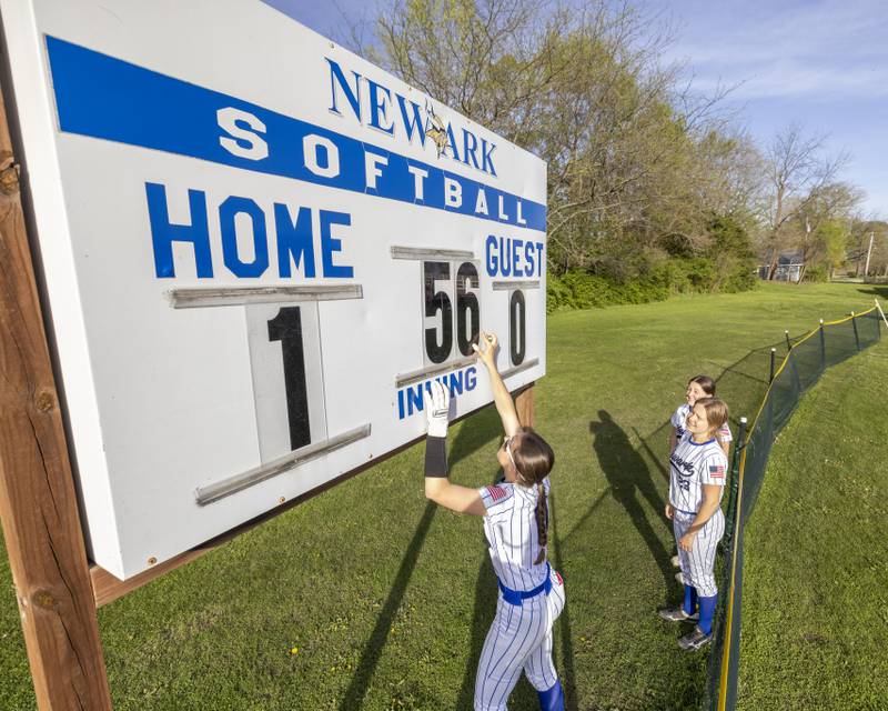 Newark softball players manually changed out the scoreboard for each run and inning number during the game against Serena High School on April 29, 2025 at Newark High School.