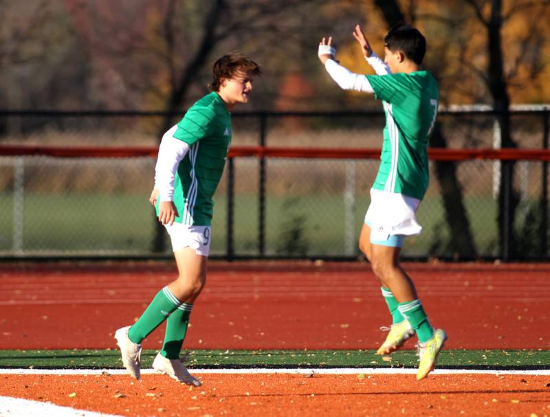 York’s Frankie Rofrano (left) and Jose Herrara (right) celebrate Rofrano’s goal in the first half of their Class 3A St. Charles East Sectional semifinal game against Addison Trail on Wednesday, Oct. 26, 2022.