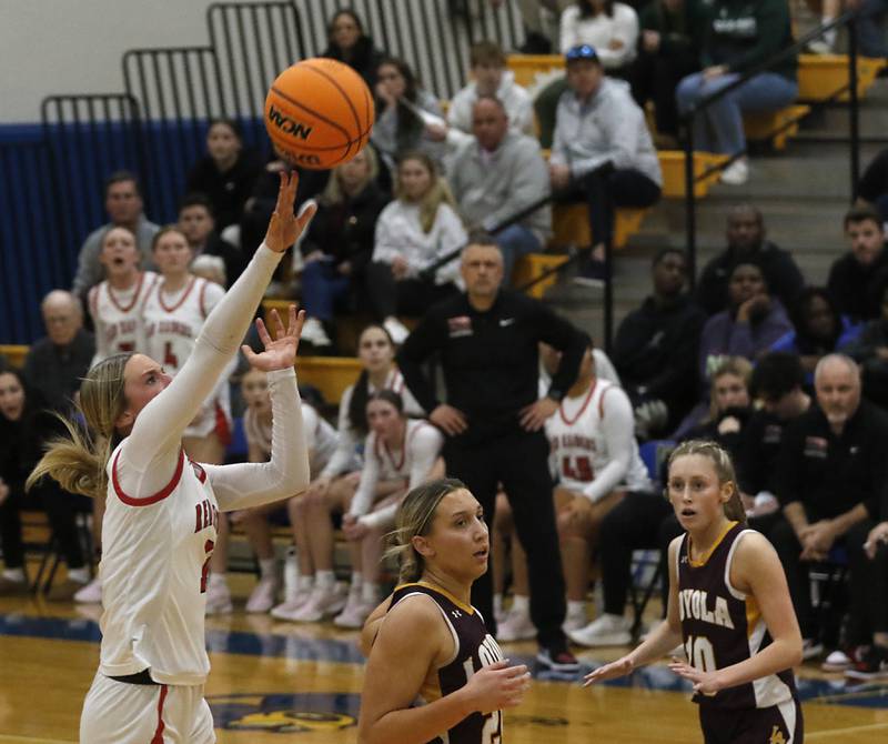 Huntley's Anna Campanelli shoots a half court shot to end the first half during the IHSA Class 4A Gurnee Warren Supersectional girls against Loyola Academy basketball game on Monday, March 3, 2025, at Warren Township High School in Gurnee.