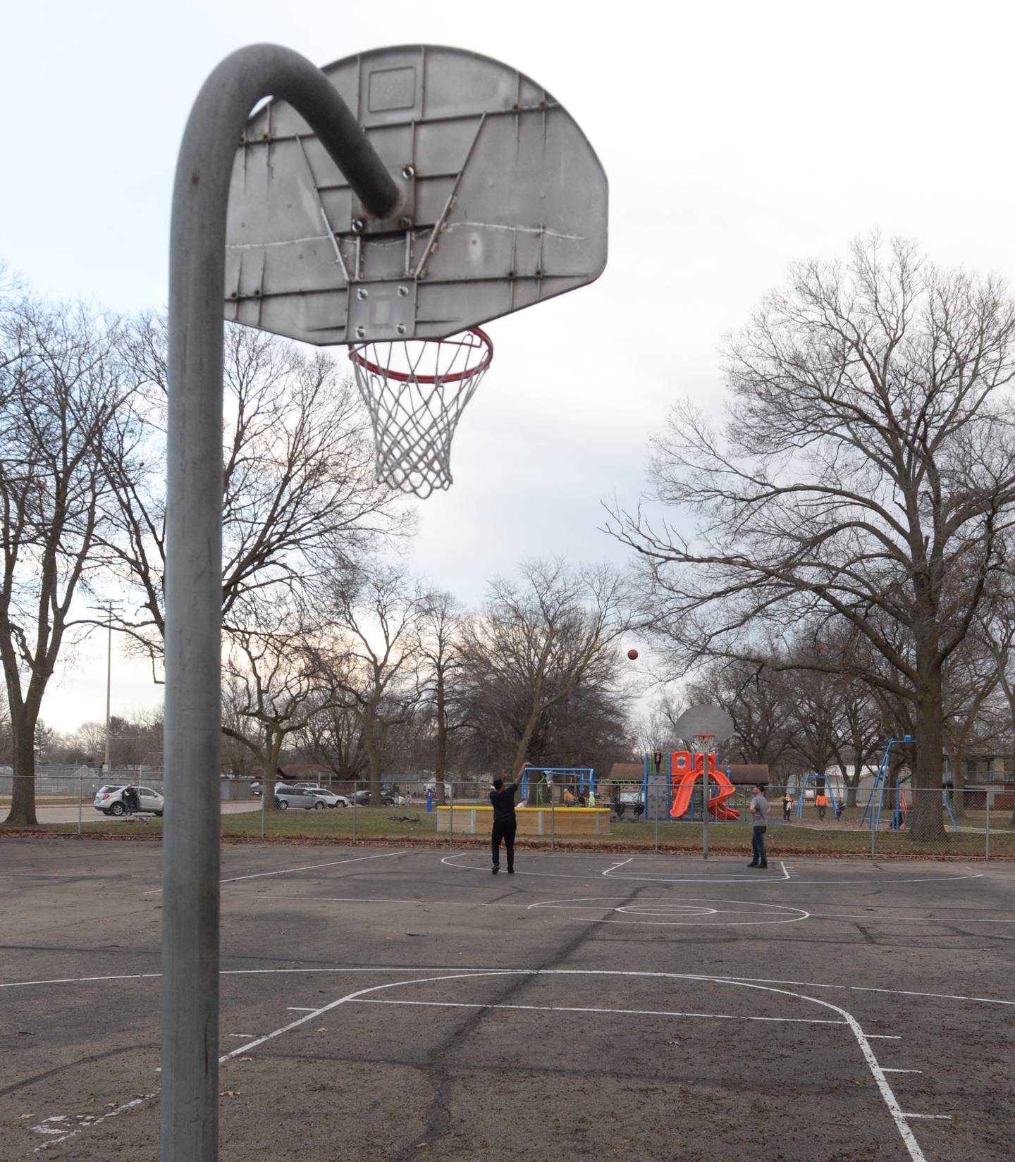 Two men shoot some hoops at the basketball court at Vaile Park in Dixon on Thursday, Feb. 8, 2024. The Dixon Park District has received a state grant to improve the court.