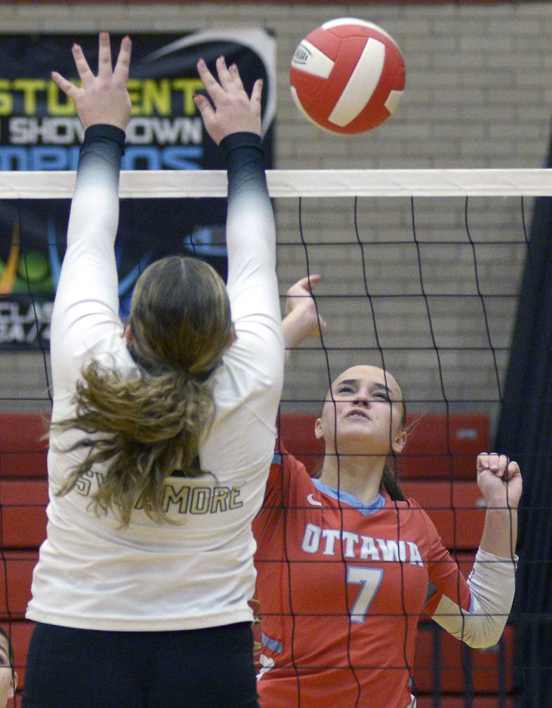 Ottawa’s Savannah Markey readies get the ball past the block attempt past Sycamore’s Sophia Lichthardt in the 1st set of Tuesday’s match at Ottawa.
