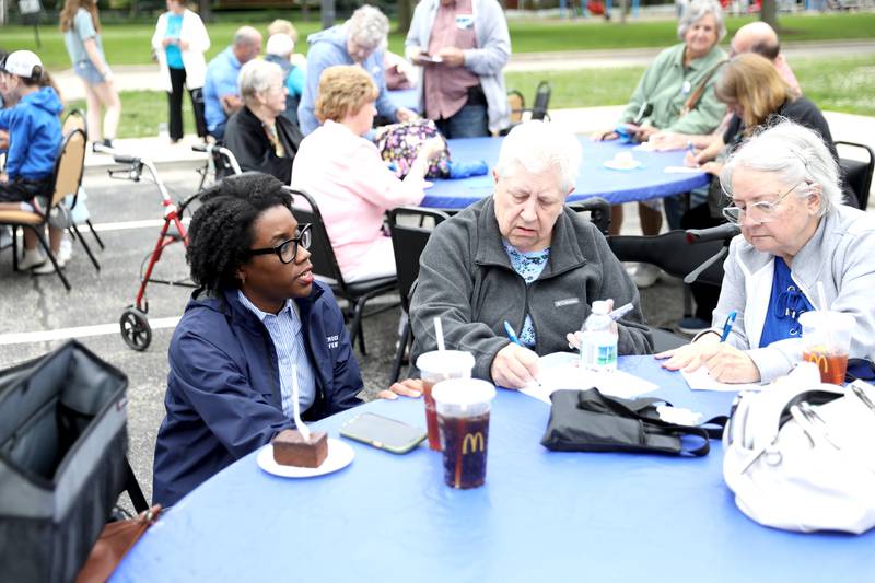 U.S. Rep. Lauren Underwood (D-Naperville) speaks to community members including Sharon Scholtes (center) and Mary Lou Martin, both of Oswego, against cuts to the federal Older Americans Act at the Senior Services Associates community center in Yorkville.