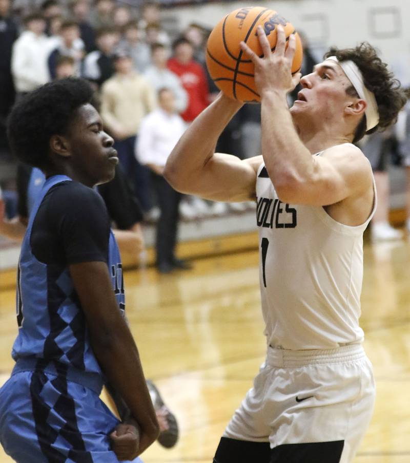 Prairie Ridge's Luke Vanderwiel (right) drives to the basket against Illinois Math & Science Academy's Mofe Suleiman during a IHSA Class 3A Burlington Central Regional quarterfinal boys basketball game on Monday, feb23, 20256, at Prairie Ridge High School in Crystal Lake.