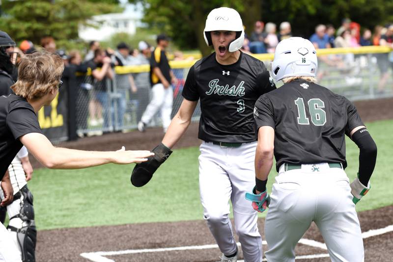 Bishop McNamara's Preston Payne, center, is congraulated by Callaghan O'Connor, left, and Braylon Ricketts after scoring a run in the Class 2A Herscher Regional championship against Herscher Saturday, May 24, 2025.