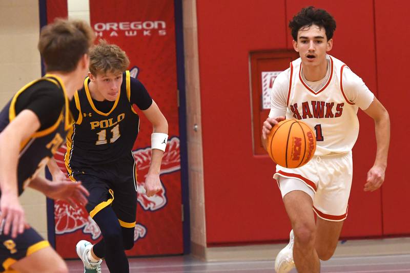 Oregon's Benny Olalde (1) starts the fast break against Polo during a Friday, Dec. 5, 2025 game at the Blackhawk Center in Oregon.