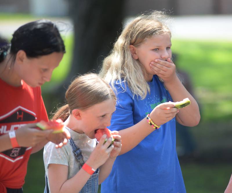 Kinley Fekman, 9, of Forreston,  (right) takes a minute to swallow a last bite of watermelon before winning one of the kids divisions at Sauerkraut Days in Forreston on Saturday, Aug. 2, 2025. The watermelon-eating contest was just one of several events offered at the festival.