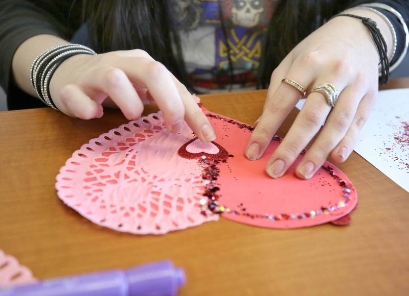 Genoa-Kingston High School freshman Mirela Music makes a Valentines Day card Tuesday, Jan. 25, 2022, in the library at the school. The cards students are making will be part of “Valentines for Seniors,” a card drive for local seniors living in residential care facilities, sponsored by State Representative Jeff Keicher, R-Sycamore, and State Senator Dave Syverson R-Rockford.