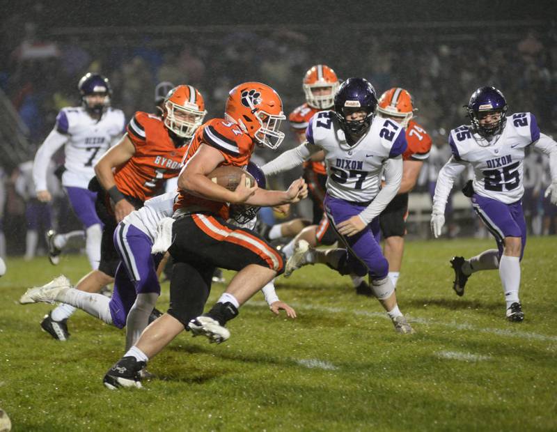 Byrpn's Caden Considine (37) runs for a big gain as Dixon's Eli Davidson (27) and Landon Knigge (25) try to catch him during first quarter action on Friday, Oct. 13, 2023 at Byron High School's Everett Stine Field.