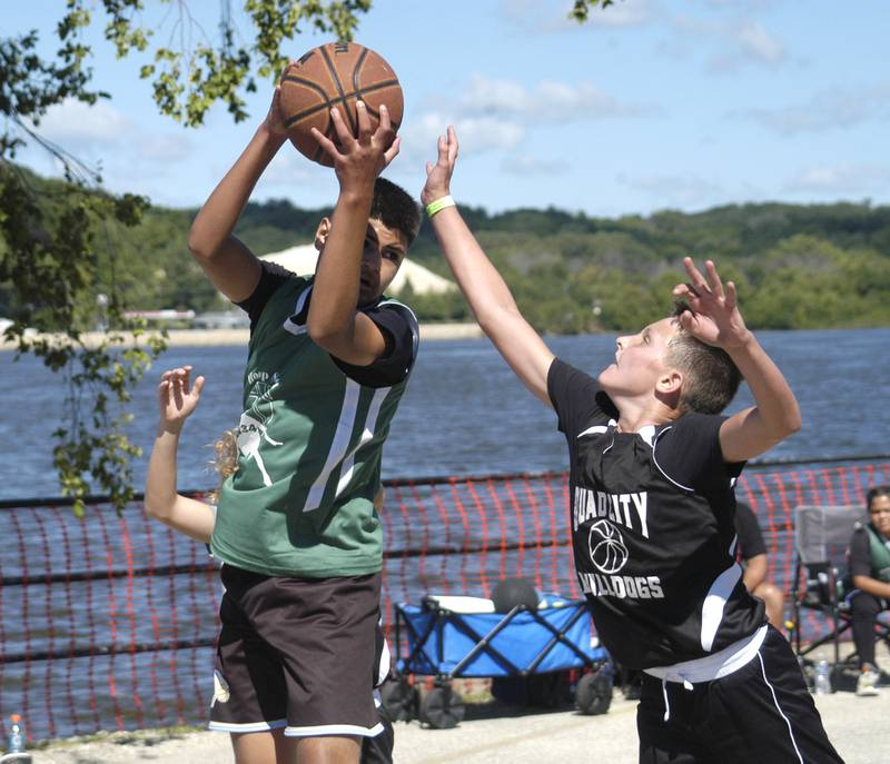 Marcus Velasquez of the Rock Falls three-man basketball team grabs a rebound. The action took place at the 3-on-3 tournament  as part of the Great River Tug Fest across the Mississippi River on Saturday, Aug. 10, 2024.
