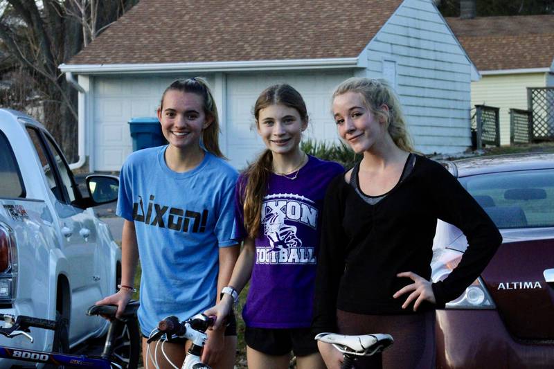 Keeley Mick, Olivia Arduini and Emma Smith are loading up their bicycles after the three completed their offseason track and field training on the Lowell Park Pathway in Dixon on Thursday.