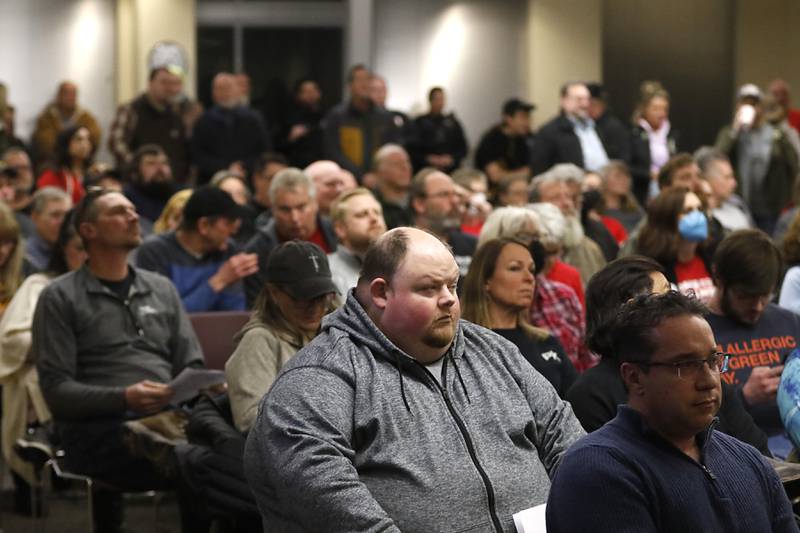 People listen to speakers Tuesday, Feb. 21, 2023, during the public comment period at the McHenry County Board meeting about the proposed resolution opposing the Illinois gun ban and supporting its repeal in the Illinois State Legislature.