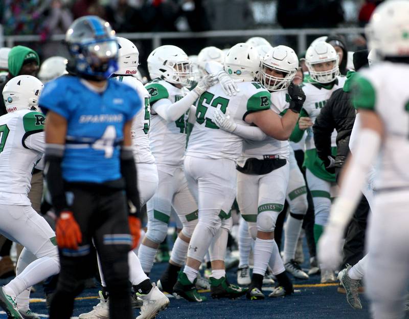 Providence players celebrate their Class 4A semifinal win over St. Francis in Wheaton on Saturday, Nov. 19, 2022.