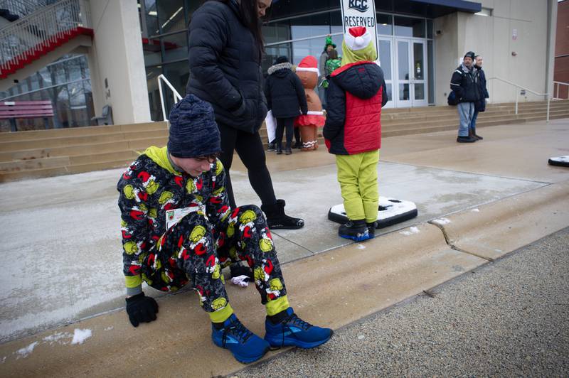 Ayden Meyer, a senior at Clifton Central High School, recovers after running in the 35th annual Jingle Bell Run at Kankakee Community College on Sunday, December 7, 2025.