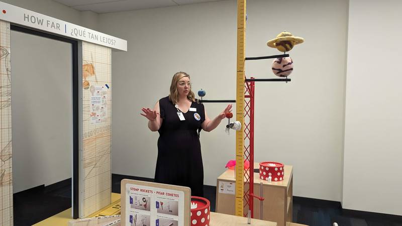 Mallory Hewlett, communications manager at the Joliet Public Library, shows one of the interactive displays in the “The Questioneers: Read. Question. Think. PLAY!” exhibit on Wednesday, June 21, 2023. This exhibit is based on the Questioneers book series authored by Andrea Beaty and illustrated by David Roberts. This traveling exhibit featuring the Questioneers characters opened June 16 at the Ottawa Street branch of the Joliet Public Library and is available during library hours through July 29.