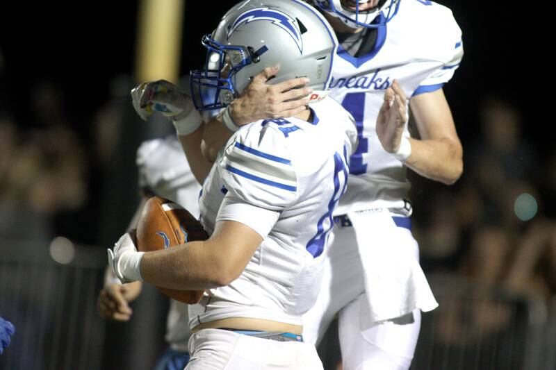Woodstock’s Keaton Perkins is greeted in the end zone on a touchdown in varsity football at Woodstock North Friday night.