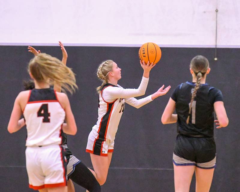 Yorkville's Aubrey Spychalski (11) goes up for a shot and gets fouled by Oswego East's Desiree Merritt (21) during the game on Thursday Dec. 18, 2025, held at Yorkville High School.