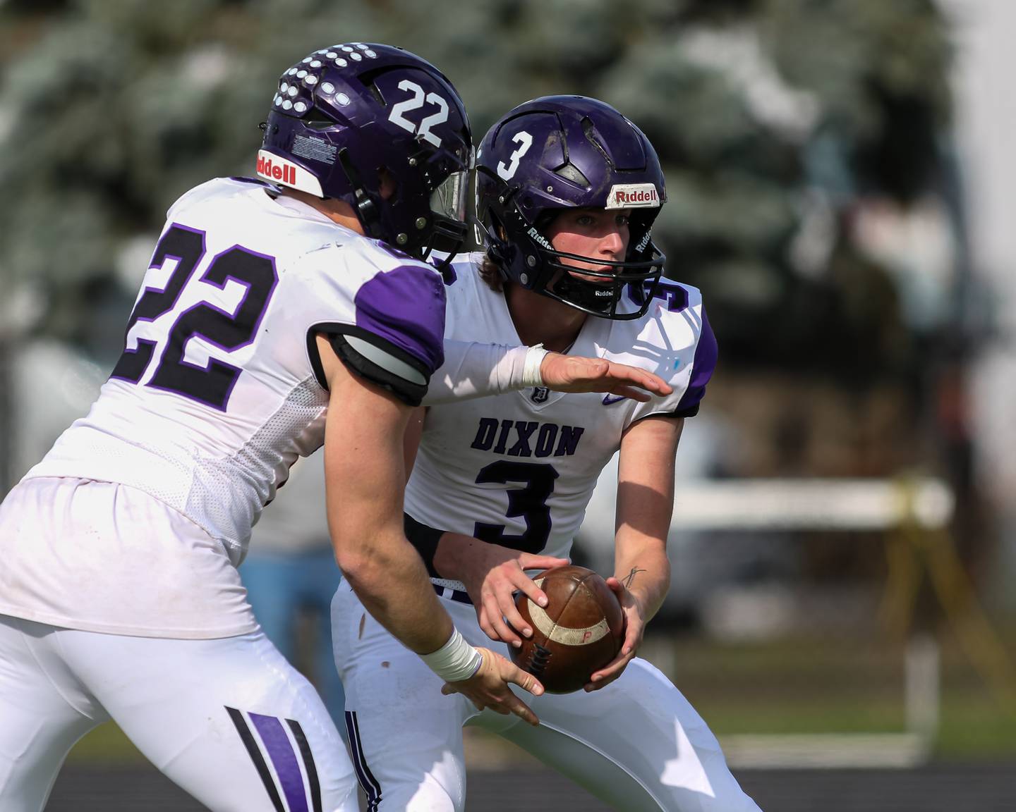 Tyler Shaner (3) hands off to Aiden Wiseman (22) during Class 4A second round playoff football playoff game between Dixon at St Laurence.  Nov 4, 2023.