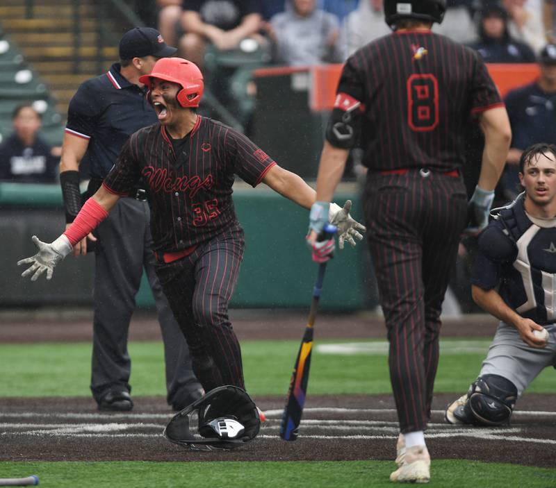 Benet Academy’s Ethan Mendez celebrates after scoring a run as Cary-Grove catcher Francis Panko holds the ball during the Class 3A state baseball semifinal at Slammers Stadium on Friday, June 13, 2025 in Joliet.