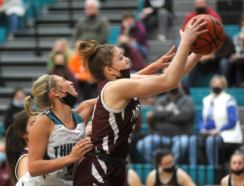 Woodstock North's Addison Rishling tries to knock the rebound away from Marengo’s Gianna Almeida during the second quarter of a Kishwaukee River Conference girls basketball between Marengo and Woodstock North Wednesday evening, Jan. 12, 2022, at Woodstock North High School.