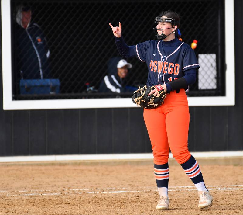 Oswego’s Rikka Ludvigson signals two outs after making a big play against Wheaton Warrenville South during a game on April 10, 2025 at Wheaton Warrenville South High School in Wheaton.