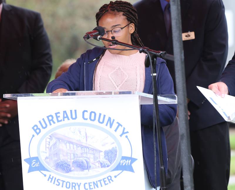 Selina Chin, a student at Princeton High School, reads the names of 45 soldiers who were from Bureau County that fought in the Civil War. All of the soldiers were African American.