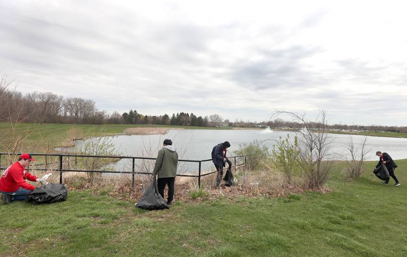 Northern Illinois University students with NIU Cares pick up garbage Friday, April 29, 2022, on campus around the West Lagoon. NIU Cares, with the help of the Trash Squirrels, was hosting a community cleanup event, going to several locations in DeKalb to pick up litter.