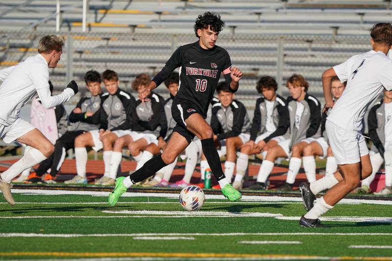 Yorkville's Lukas Kleronomos (10) moves the ball up the field against Oswego East during a soccer match at Yorkville High School on Tuesday, Oct. 15, 2024.
