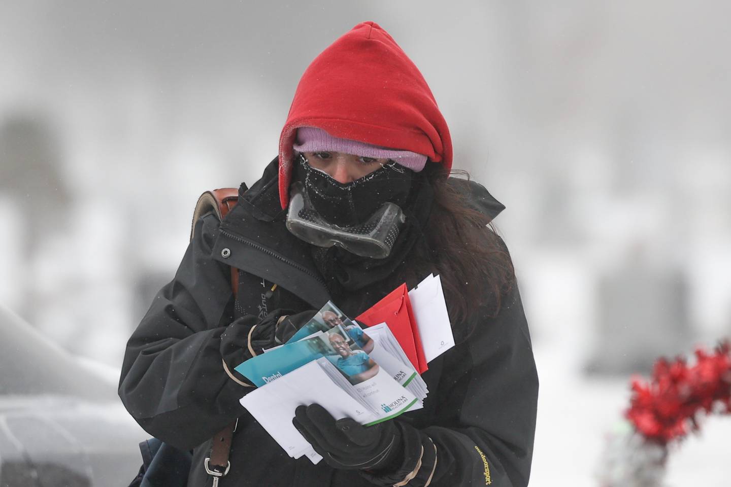 A US postal worker bundles up as she delivers mail in bellow zero temperatures in Joliet.