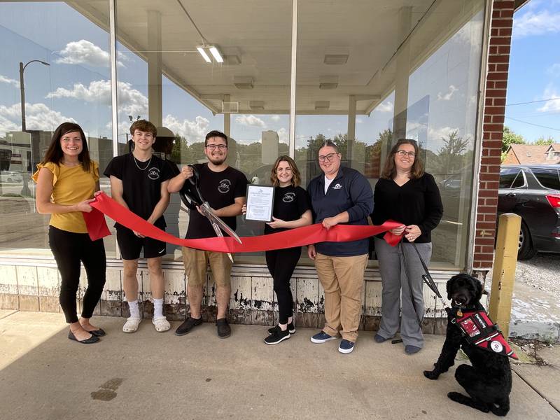 Courtney Levy, Streator Chamber director; Blake Billups, of O'Bees; Max and Jessica O'Brien, owners of O'Bees; Katie Cox, chamber ambassador; and Beth Palm, chamber board member cut a ribbon commemorating Obee's relocation.