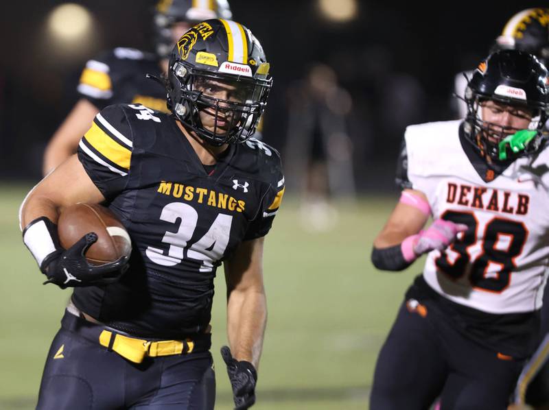 Metea Valley's Hani Omar gets by DeKalb’s Otto Eidsness for a good gain during their game Friday, Sept 15, 2023, at Metea Valley High School in Aurora.