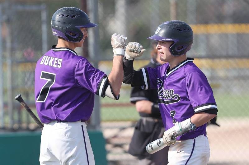 Dixon's Gage Burdick (left) congratulates Beau Evans after he scored a run during their game against Sycamore Thursday, May 19, 2022, at the Sycamore Community Sports Complex.