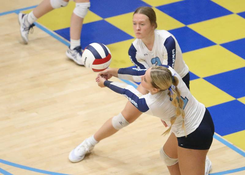 Marquette's Greysyn Carrier returns a serve to Newark as teammate Emily Ryan Adair watches on Wednesday, Aug. 27, 2025 in Bader Gymnasium.