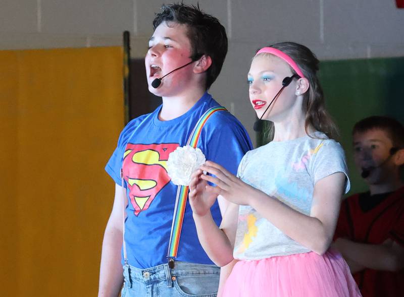Jack McCray as Jesus and Alayna Pinter act out a scene while performing in "Godspell  Jr." on Friday, March 27, 2026 at  Academy of Saints Carlo Acutis school in Oglesby.