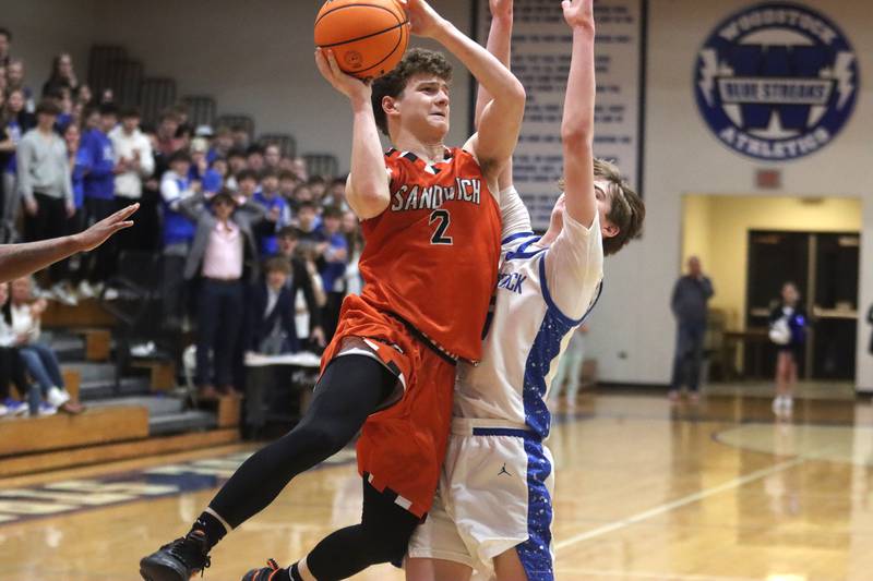 Sandwich’s Griffin Somlock shoots during the OT period in varsity boys basketball on Tuesday, Feb. 11, 2025, at  Woodstock High School in Woodstock.