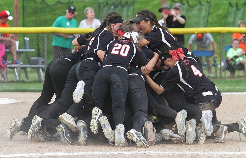 Huntley celebrates winning the Class 4A state championship over St. Charles East on Saturday in East Peoria. The Red Raiders won, 1-0, in eight innings to capture the program's first title.