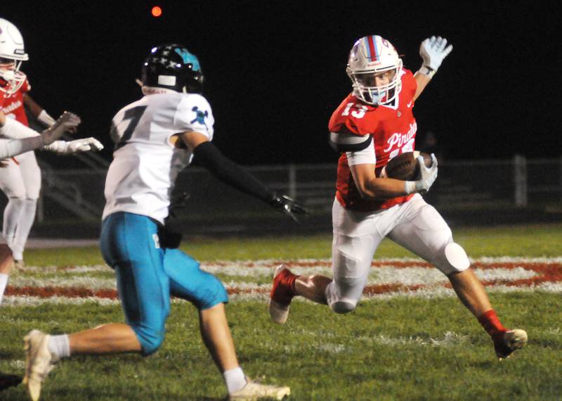 Ottawa's Ryder Miller (13) avoids a tackle by Woodstock North's George Kingos at King Field on Friday, Sept. 29, 2023.