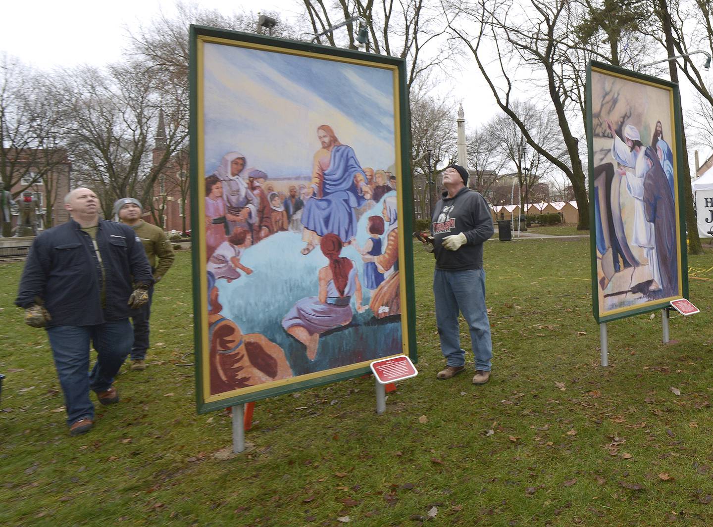 Volunteers check their work after putting up the 16 paintings depicting the life of Christ at Washington Square in Ottawa. The Ottawa Freedom Association has erected the paintings each year since 1992 after winning a lengthy court battle.