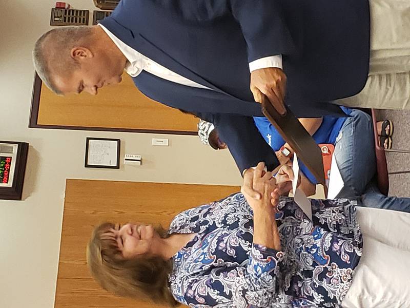 Former District 202 Foundation Chair Margie Bonuchi presents the Niehus Award to Dr. Lane Abrell, citing his more than 20 years of leadership, including nine years as assistant principal and principal at Plainfield High School.