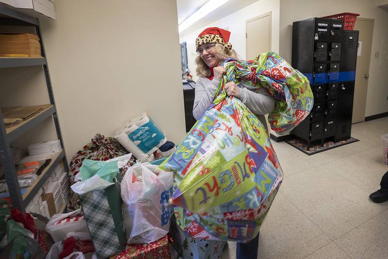 Joy Colbert hauls gifts out to the squad car Monday, Dec. 23, 2024, for Rock Falls Police’s annual Operation Santa. Through donations from the community, the police and fire departments were able to provide a Merry Christmas to 11 families this year.