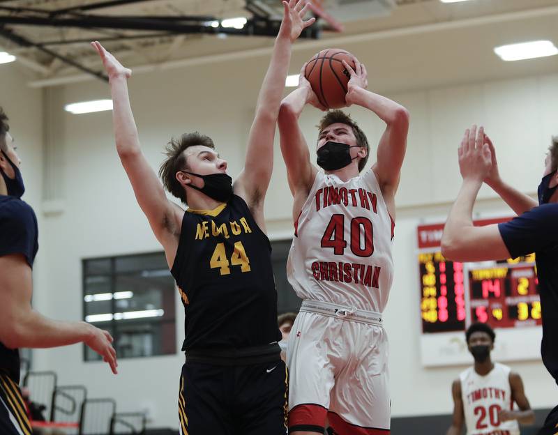 Timothy Christian's Ben VanderWal puts up a shot against Neuqua's Connor Davis in Elmhurst Feb. 6.