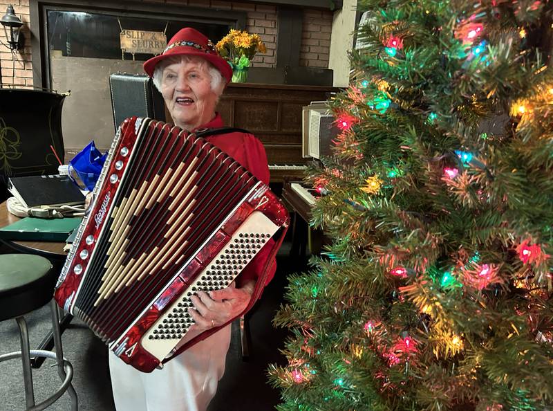 Bev Kearns of rural Dixon plays the accordion at Conover Square during Oregon's Candlelight Walk on Saturday, Nov. 30, 2024. Piano players and other musicians provided music throughout the evening during the annual event.