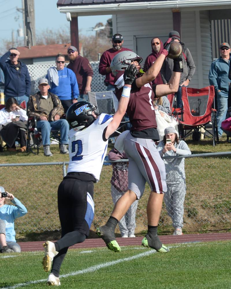 Rockridge's Treveor Dye (1) catches a pass despite the defensive effort of Eastland-Pearl City's Sawyer Williams (2) in the 2A state football playoff's first round on Saturday, Nov. 2, 2024 at Eddington.