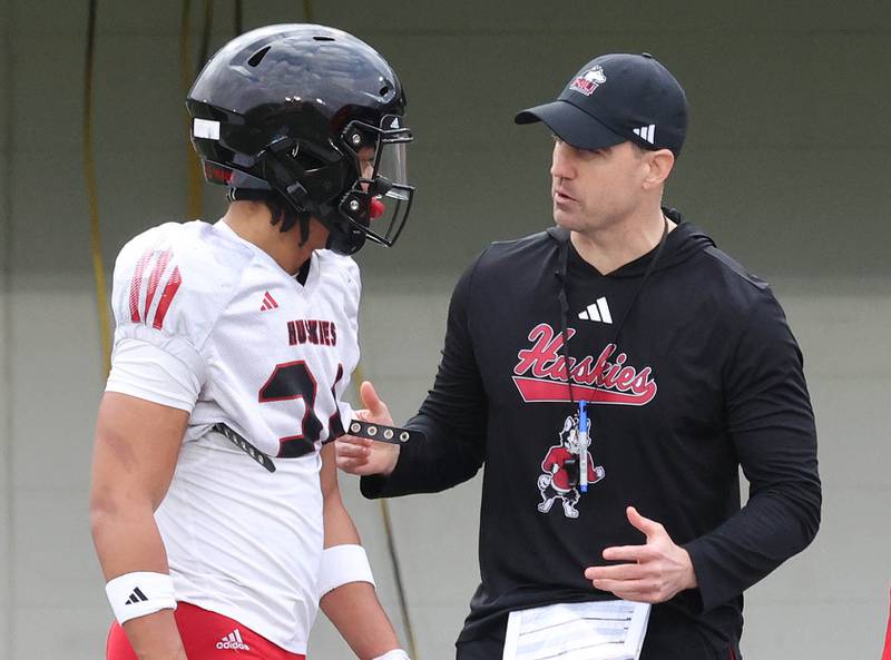 Northern Illinois University head football coach Rob Harley talks to defensive back Justus Donahoo Tuesday, April 14, 2026, during spring practice in Huskie Stadium at NIU in DeKalb.