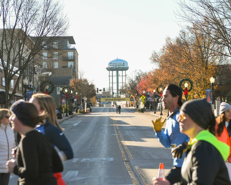 Participants run the Grove Express 5k race held in downtown Downers Grove on Thursday Nov. 23, 2023.
