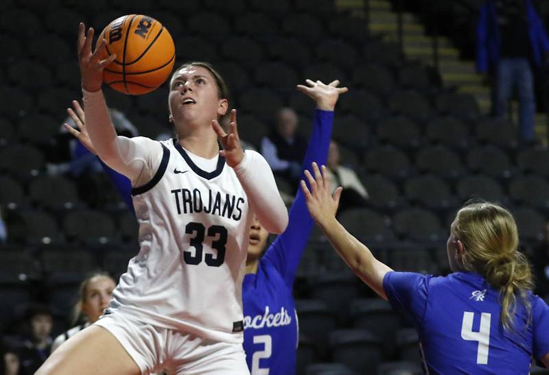 Cary-Grove's Elizabeth Mjaanes (left) splits the defense of Burlington Central's Jordyn Charles (center) and Ashley Waslo (right) during a Fox Valley Conference basketball game  on Tuesday, Jan. 14, 2025, at Now Arena in Hoffman Estates.