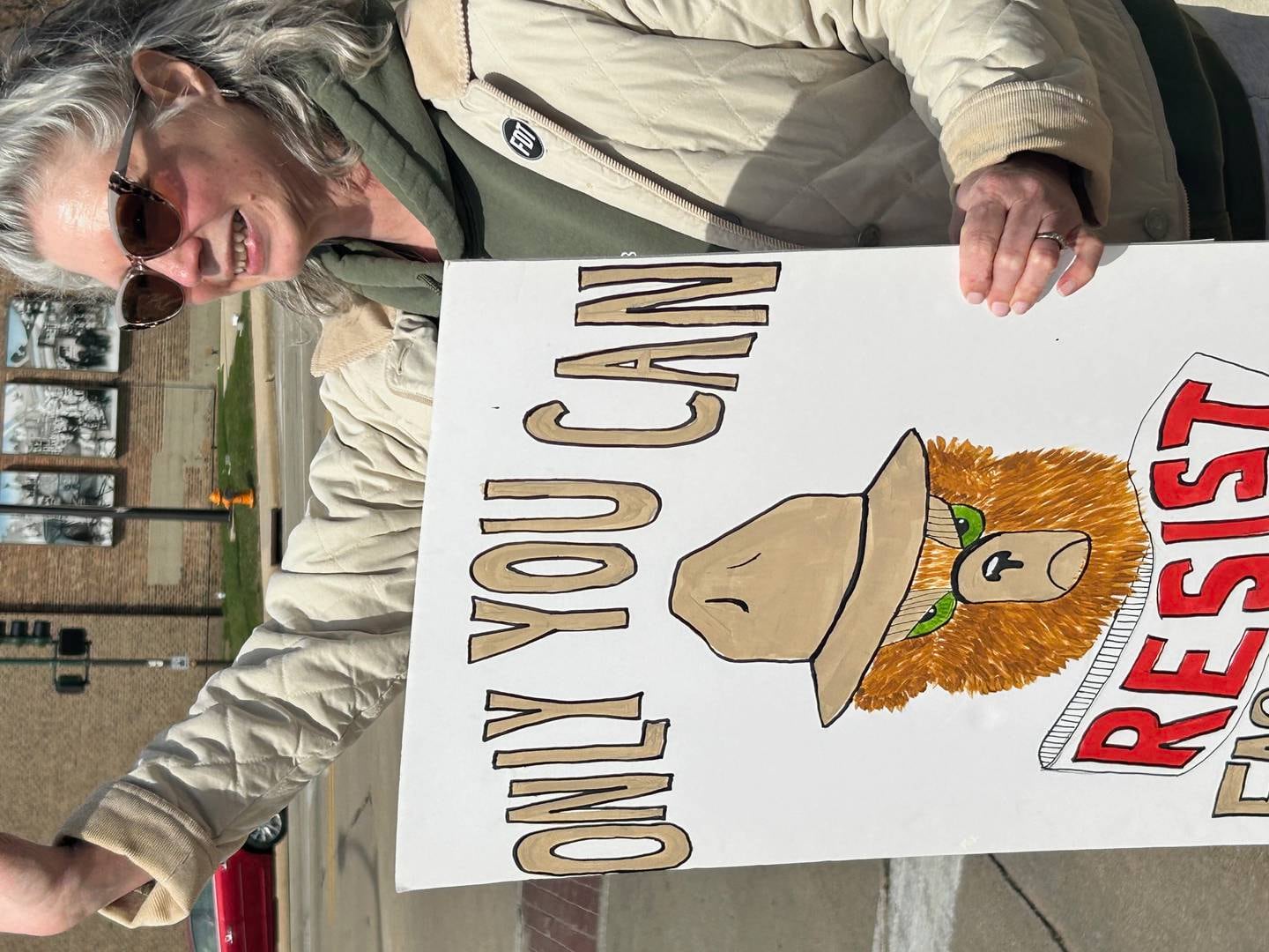 Carol Bearman of Dixon waves to traffic Saturday during a No Kings protest along Galena Avenue in Dixon.