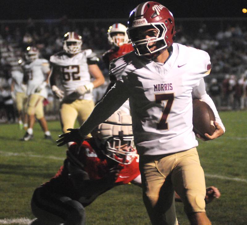 Morris quarterback Brady Varner (7) runs out of bound to avoid a tackle by Ottawa's George Shumway on Friday, Oct. 10, 2025 at King Field in Ottawa.