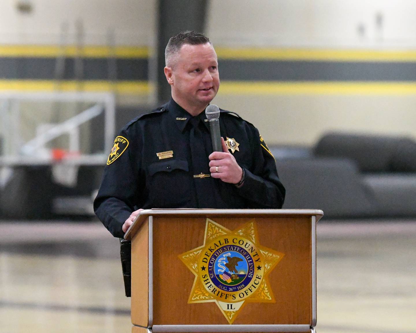 DeKalb County Sheriff Andy Sullivan speaks about the late sheriff's deputy Christina Musil, 35, during a memorial vigil on Saturday, March 29, 2025, held at the Sycamore High School Field House. Musil was killed in the line of duty in a rear-end car crash in Waterman while on patrol on March 28, 2024.