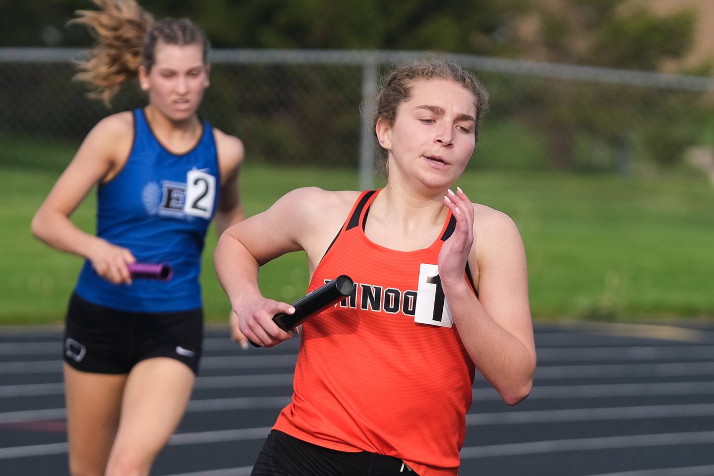 Minooka’s anchor Kathryn Cichon pulls away from Lincoln-Way East’s Maura Hanrahan to win the 4x800 meter relay at the Class 3A Minooka Girls Sectionals. Wednesday, May 11, 2022, in Minooka.