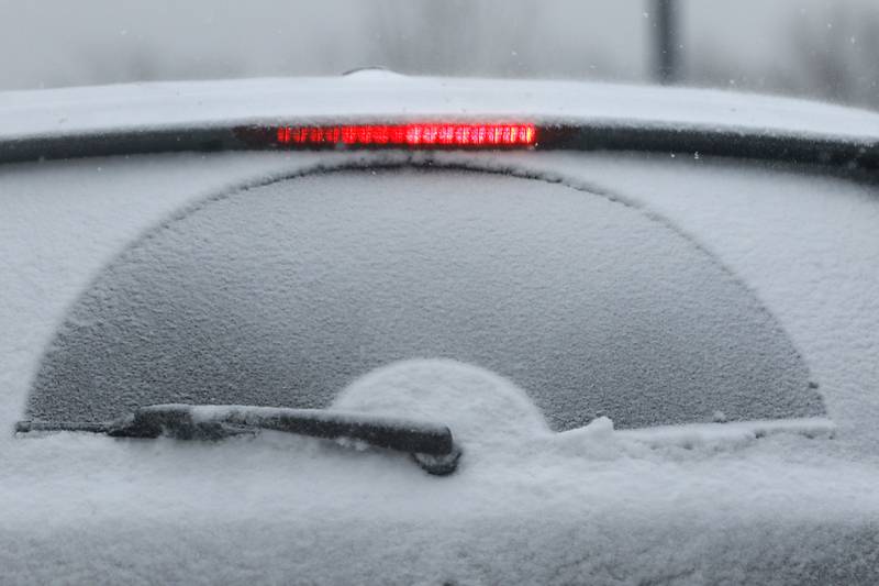 Snow covers the back of a car on Wednesday, Feb. 12, 2025, in Crystal Lake as a winter storm starts to bring heavy snow to the McHenry County area
